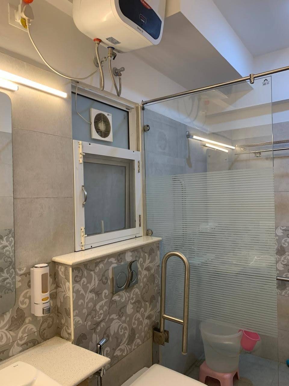 Bathroom with glass shower partition and geyser